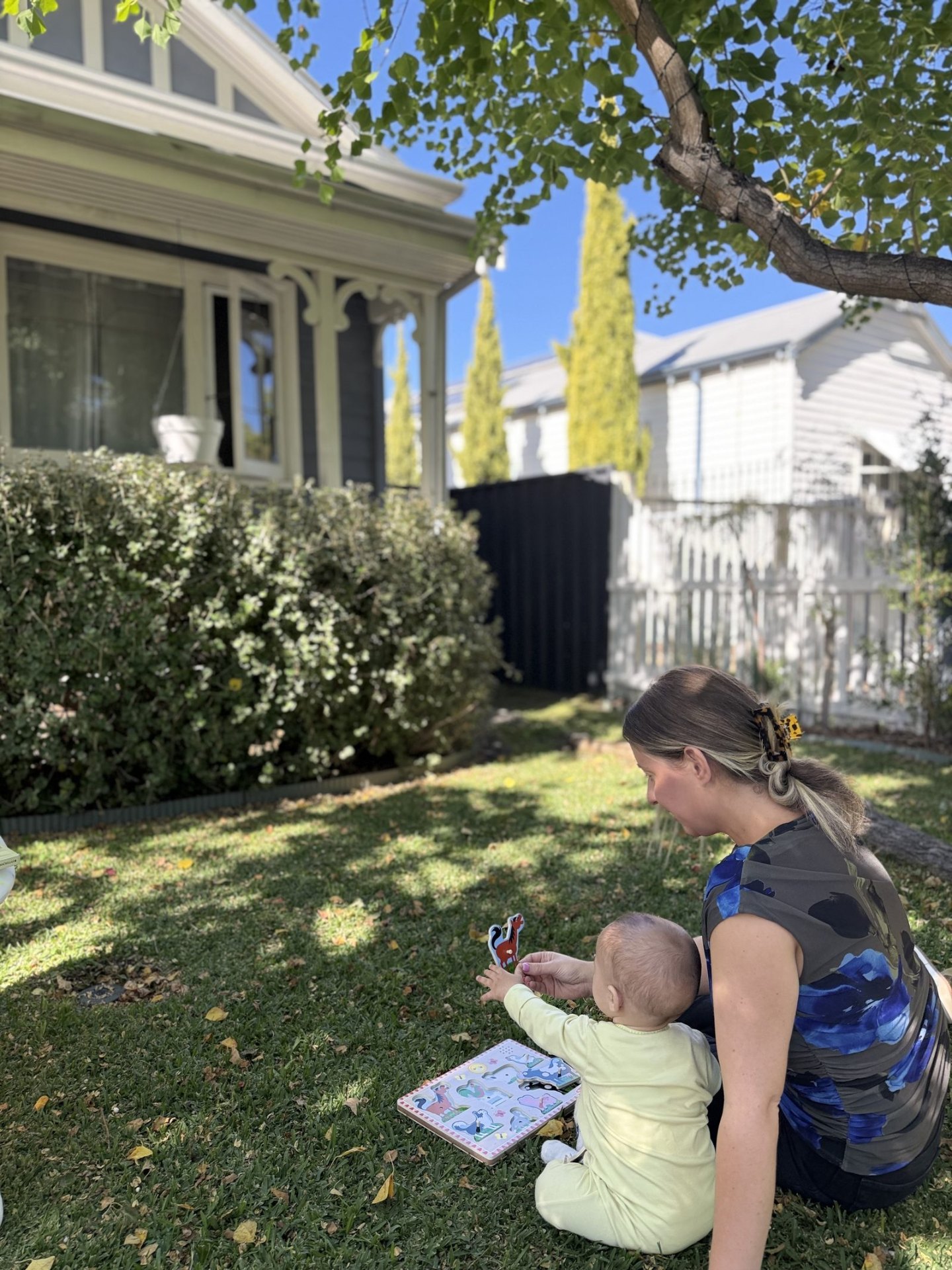 Speech pathologist working with a baby on early language using a picture book